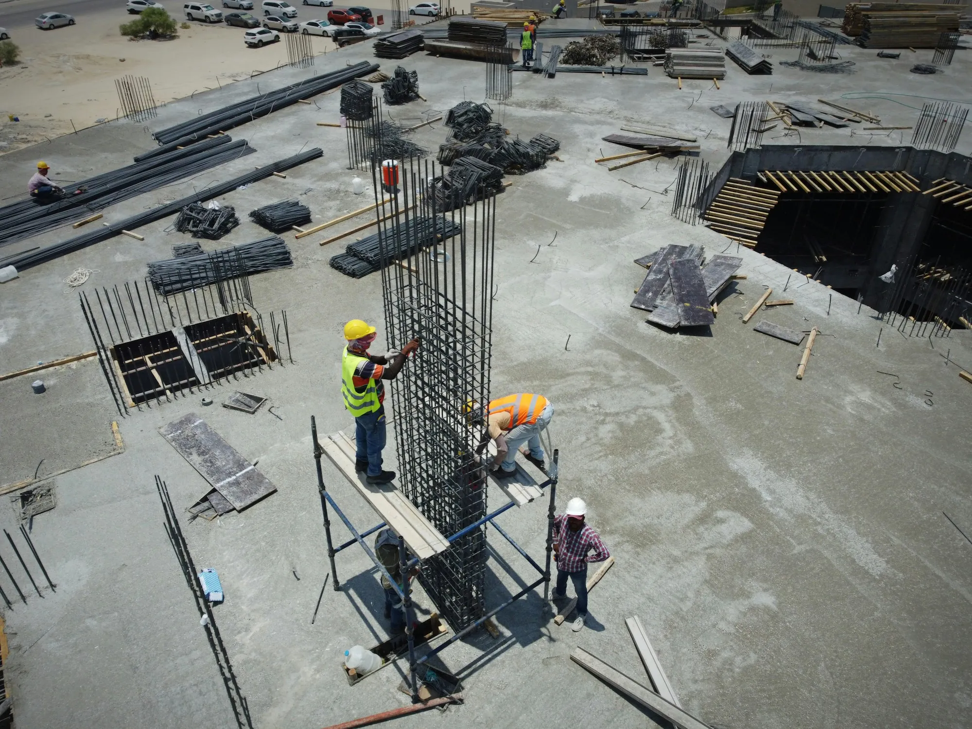 Rebar columns rising from a poured concrete slab