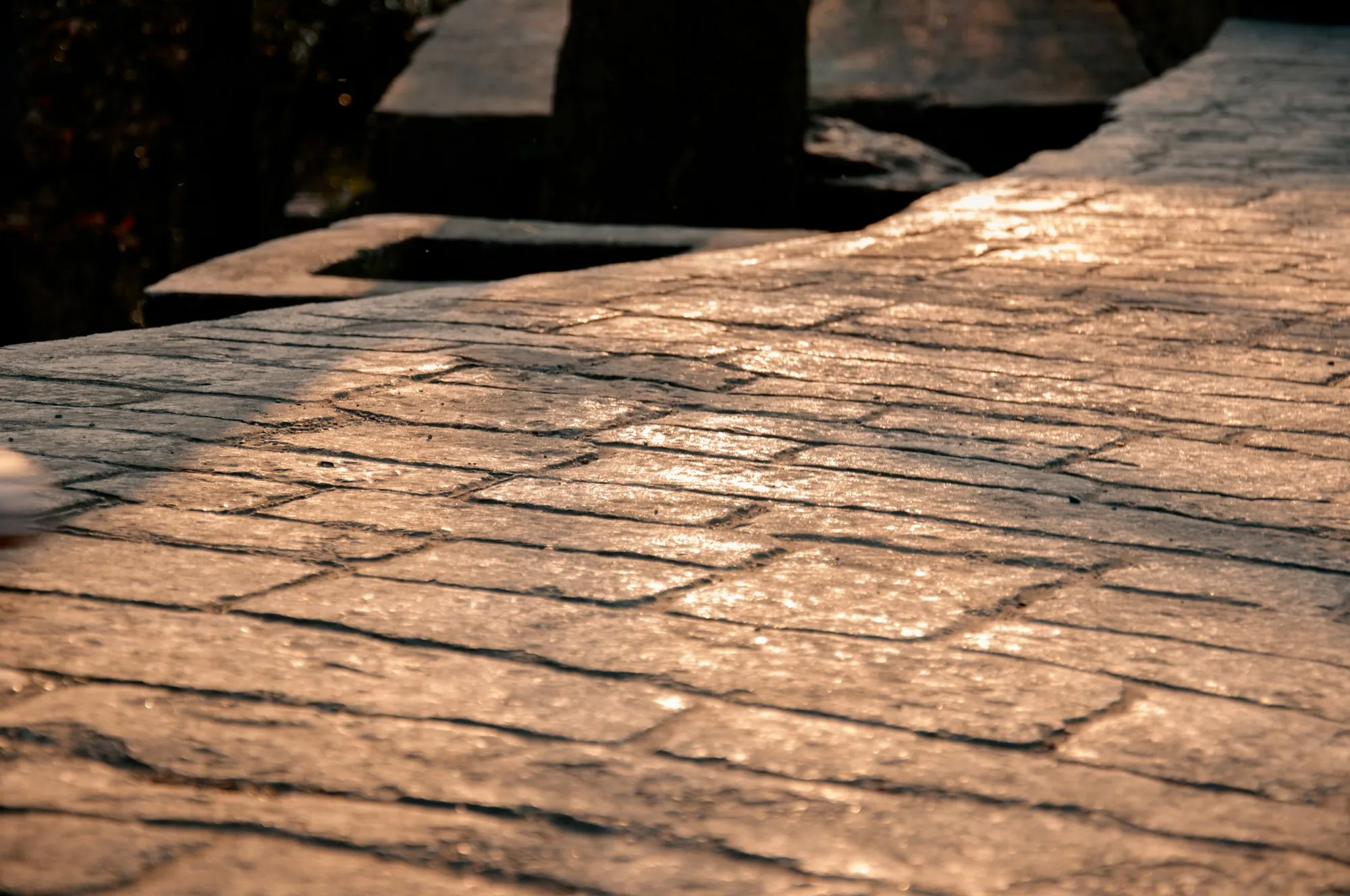 Stamped concrete with a wood plank texture in warm light
