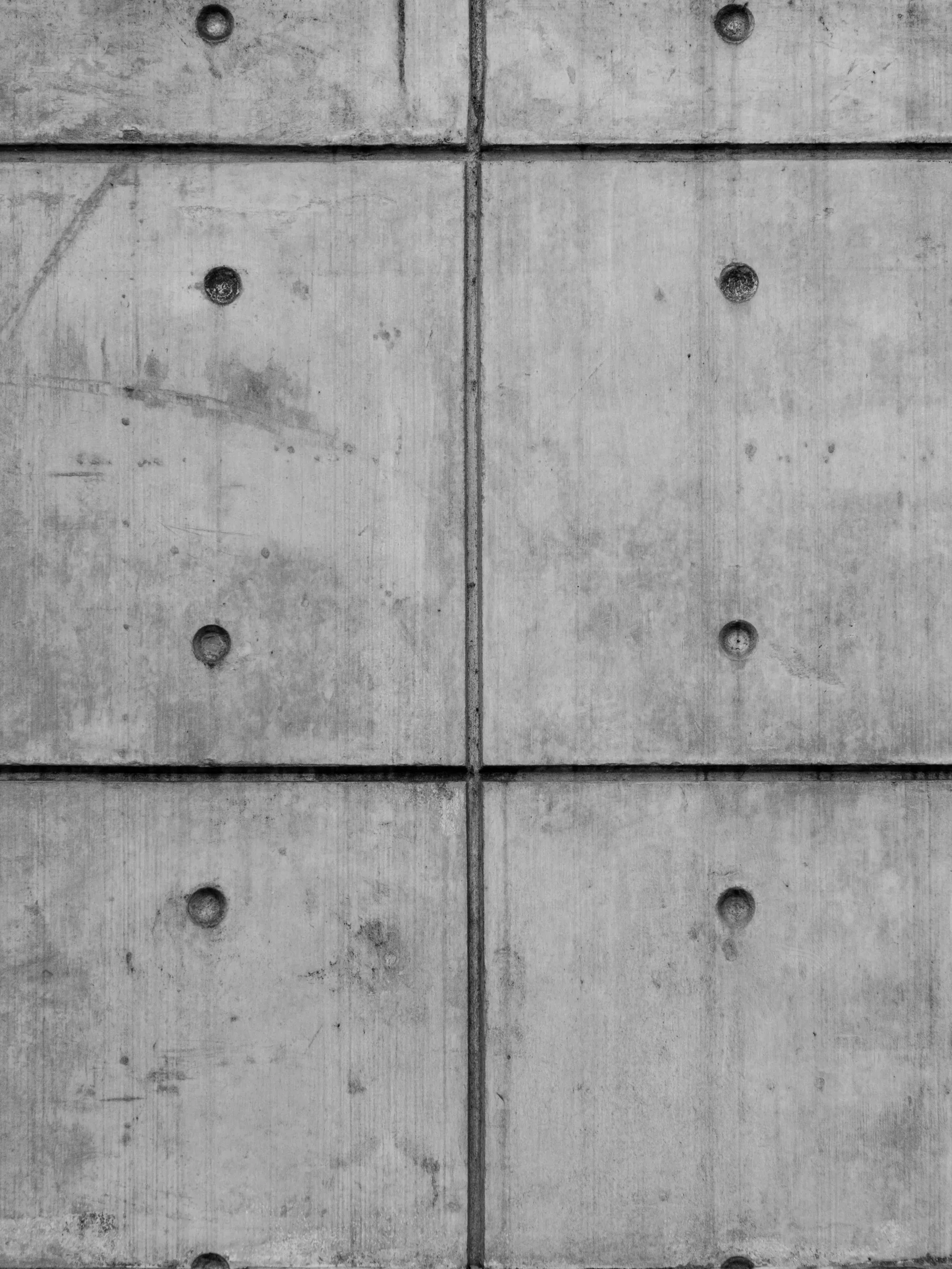 Formed concrete wall with tie holes and panel seams